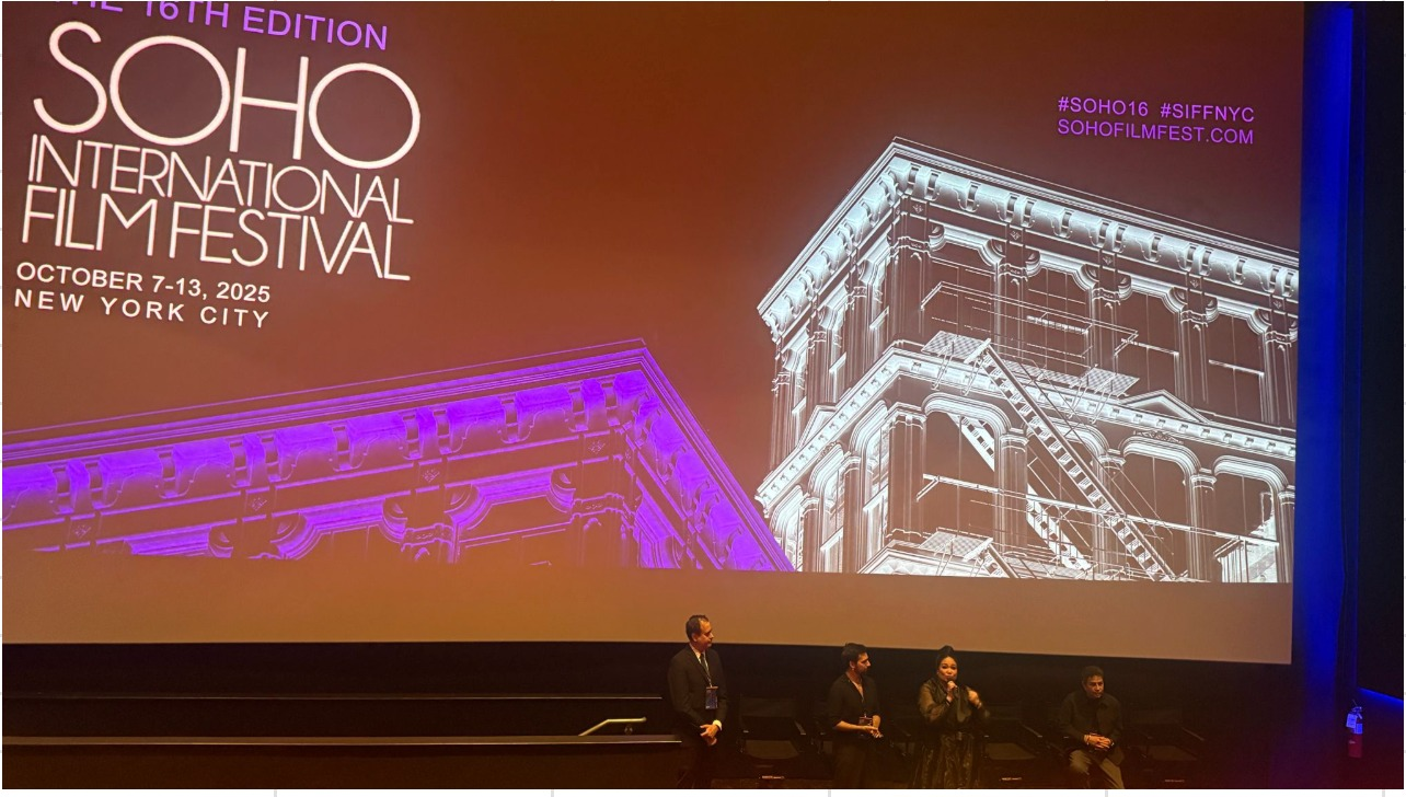 SOHO International Film Festival screen above four people taking part in an on-stage discussion.
